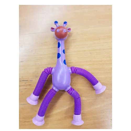 Plastic toy in the shape of a giraffe in purple. The giraffe's legs can be extended, and there are suction cups at the ends of the legs that can be attached to a window, furniture, etc. Product sold online, in particular via Shein (unique identifier: sl2501076151622677)