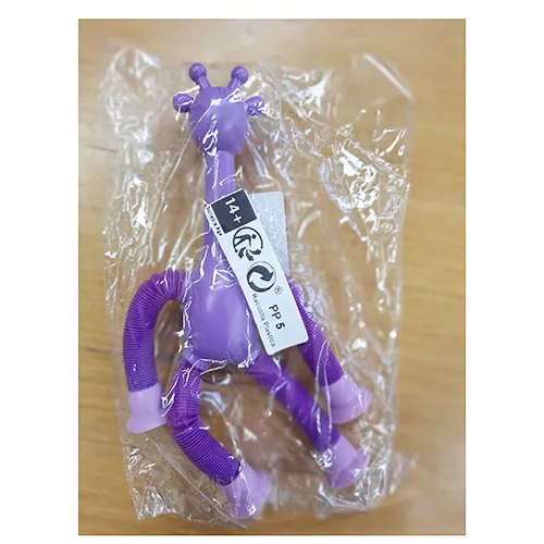 Plastic toy in the shape of a giraffe in purple. The giraffe's legs can be extended, and there are suction cups at the ends of the legs that can be attached to a window, furniture, etc. Product sold online, in particular via Shein (unique identifier: sl2501076151622677)