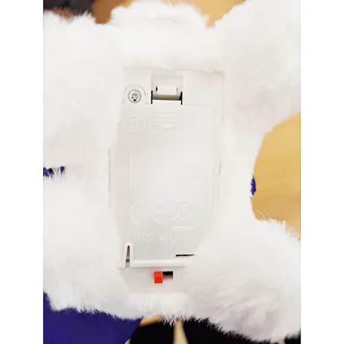 Electronic plush toy in the shape of a puppy with a red ribbon and collar with bell. Product sold online, in particular via Shein (unique identifier: sl2311262284392222).