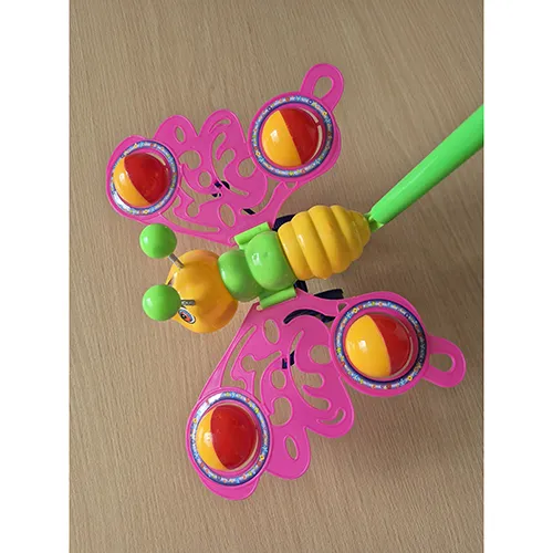 Hard plastic butterfly toy in orange, yellow, blue and green on two wheels with a push handle. The wheel axle and fasteners (bolts) are made of metal. Colourful stickers with plastic film are glued to the toy. When pushed, the butterfly moves, crackles and flaps its wings.