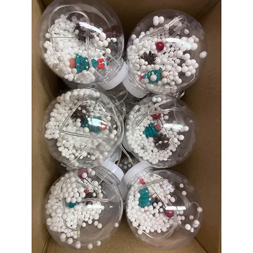 Lighting chain with ten plastic spherical ornaments with styrofoam balls and pine tree decorations.