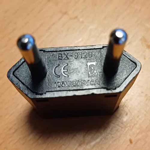 Travel adaptor in black or white with class II EURO plug and socket outlet for US class II Type A and schuko plug.