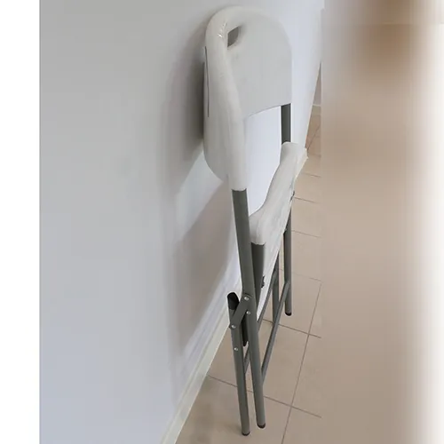 Plastic folding chair with a white plastic seat and backrest.