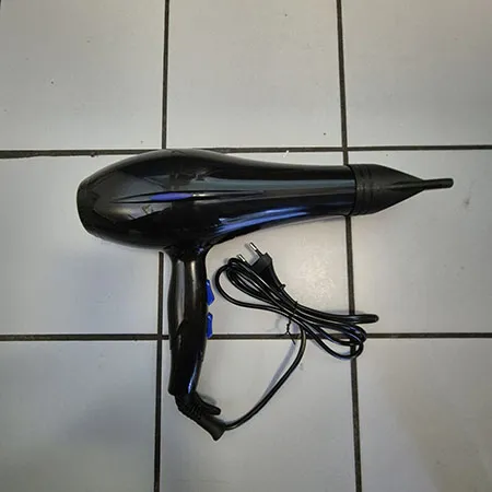 Black hair dryer with blue buttons.