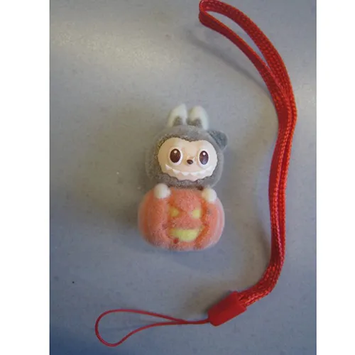 Soft toy, made of plastic and felt, in the shape of a Labubu-like doll. The toy includes a strap. Production date: June 2025.