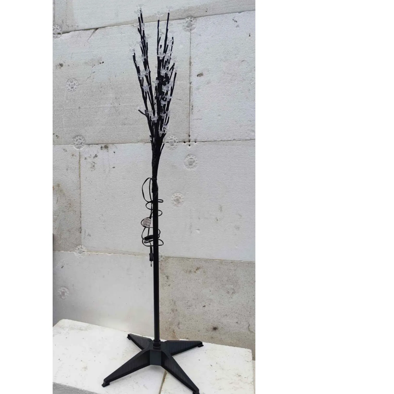 Yellow lighting chain with LED lights in the shape of a tree.