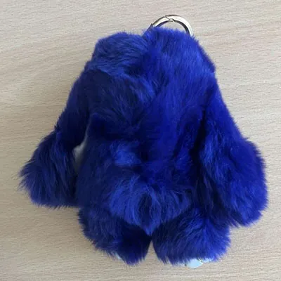 Blue plush keychain in the shape of a rabbit with black leatherette paws and a gold-coloured metallic ring. Product sold online, in particular via Amazon (ASIN: B0DM5C9786).