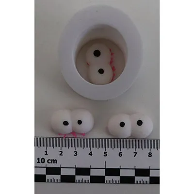 Squeezable toy in the shape of a caterpillar with big eyes.