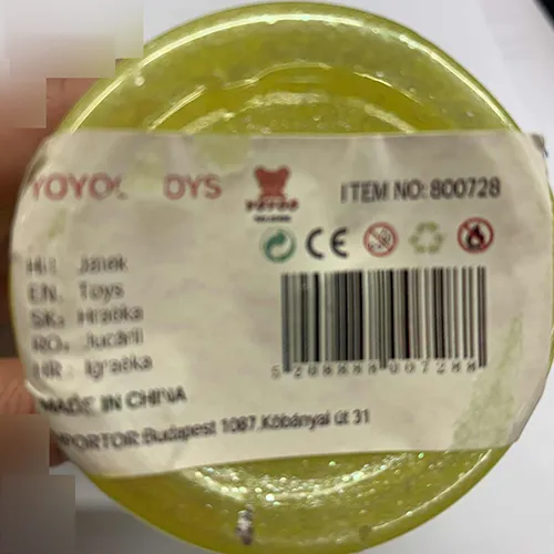 Yellow toy slime packaged in a plastic container with a green lid decorated with ears and star patterns.