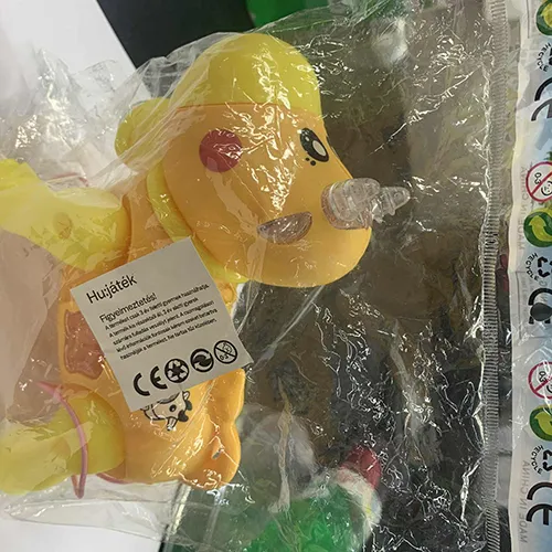 Plastic battery-operated, has wheels and an attached string. The toy is in the shape of a cow, with painted eyes and cheeks, horns, and a transparent bell attached to the neck.