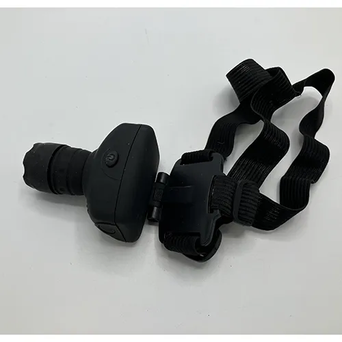 Black hard plastic headlamp with a textile strap. Product sold online, in particular via Garderoben.se.