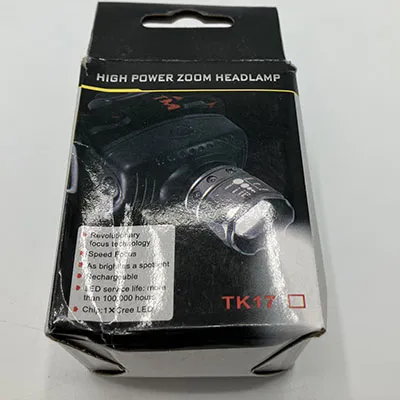 Black hard plastic headlamp with a textile strap. Product sold online, in particular via Garderoben.se.