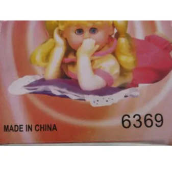 Battery-operated doll with blonde hair tied in two ponytails with red bows, dressed in a red dress with polka dots.