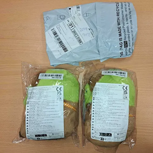 Brown and green plush toy in the shape of a capybara wearing a frog head cover and a detachable frog mask. Product sold online, in particular via Shein (unique identifier: sl25060321981221271).