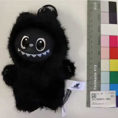 Soft toy in the shape of black Labubu-like monster with a keyring.