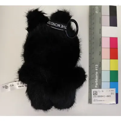 Soft toy in the shape of black Labubu-like monster with a keyring.