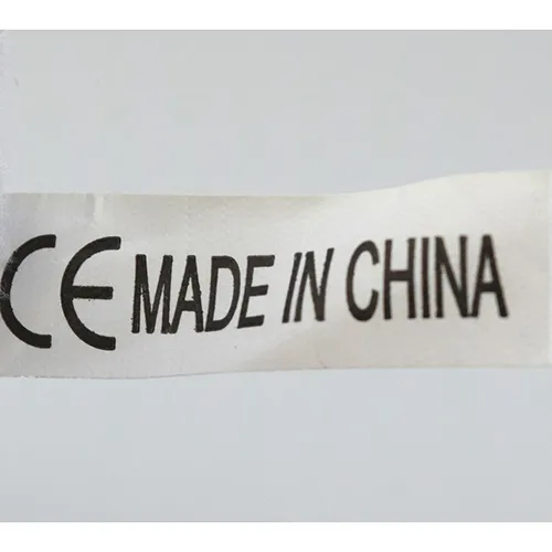 Grey plush figure in the shape of an animal with pink plush covering on the belly.