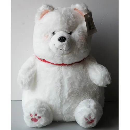 White plush toy in the shape of a bear with a red collar studded with bone-shaped studs.