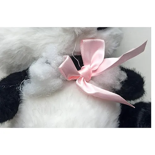 Black and white plush panda toy with a pink ribbon around its neck.