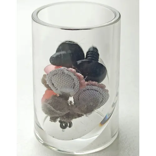 Black and white plush panda toy with a pink ribbon around its neck.