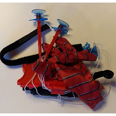 Glove with a trigger mechanism and suction cup darts. Product sold online, in particular via Shein (unique identifier: sl25060350202153043).