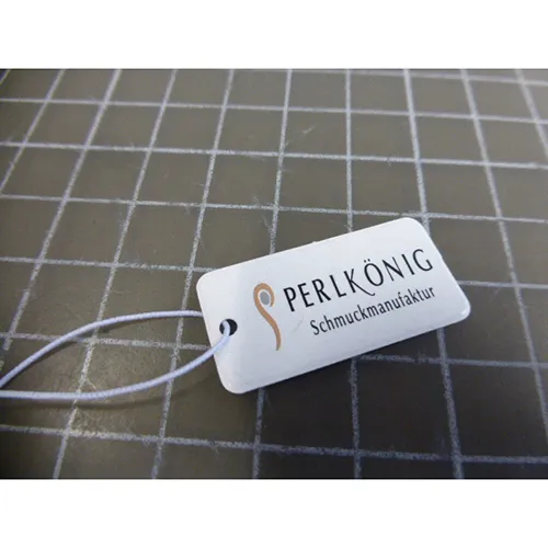 Silver-coloured metal necklace with silver, black and gold-coloured metal pendants, a closure and a chain extender.