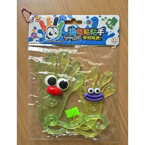 Plastic toy, yellow and green elastic adhesive hands with faces and strings ending in loops.