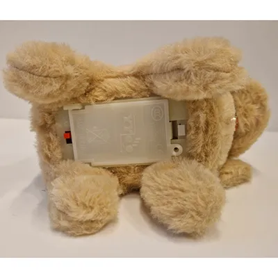 Soft toy in the shape of a dog with a batteries compartment.