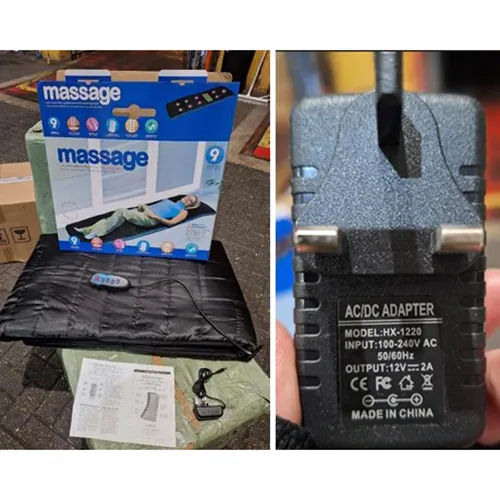 An electronic massage mat with attached wall plug.