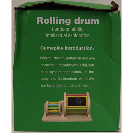 Wooden toy set consisting of one cylinder with its sides made of bars, containing balls; one wooden section with a support for the cylinder on one side and a rotating cylinder with a mirror on the other side Product sold online in particular via montessoritoddlers.com.