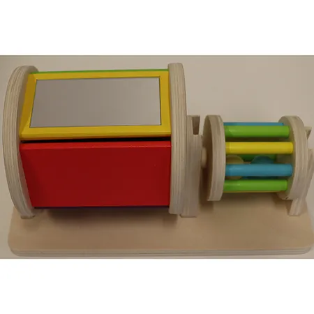Wooden toy set consisting of one cylinder with its sides made of bars, containing balls; one wooden section with a support for the cylinder on one side and a rotating cylinder with a mirror on the other side Product sold online in particular via montessoritoddlers.com.