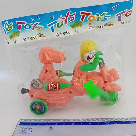 Colourful plastic toy motorcycle with a clown face on the driver spot and an inertial mechanism, pulled by a string.