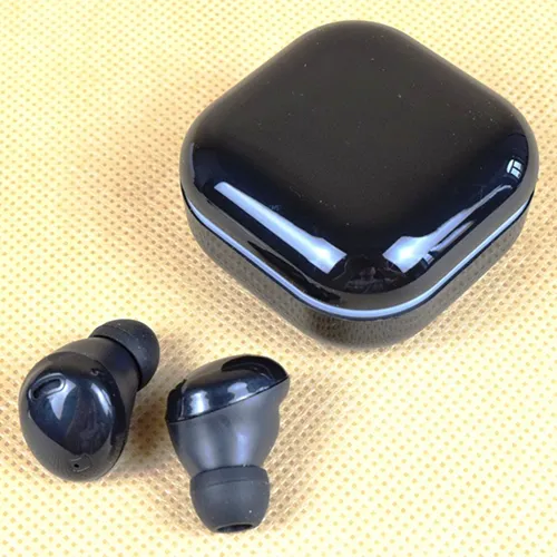 Black wireless earphones with charging cable.