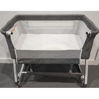 Grey baby bassinet with wheels and a mosquito net.