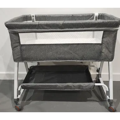 Grey baby bassinet with wheels and a mosquito net.