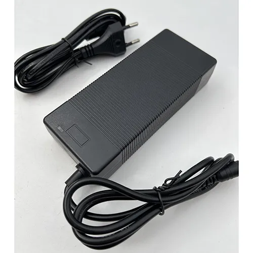 Black charger for electric bikes and scooters with a wall plug. Product sold online, in particular via fruugo.com.