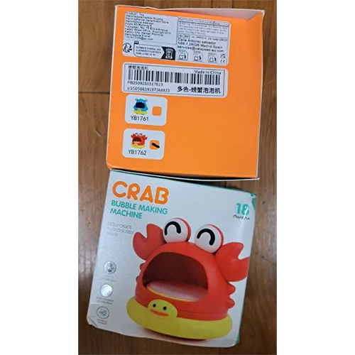 Red and yellow bath toy in the shape of a crab, with an opening to blow bubbles. Product sold online, in particular via Shein (unique identifier: sl25050839197368833).
