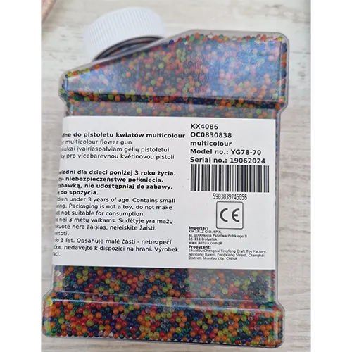 Multicoloured water beads, which grow when immersed in water, intended for use as bullets in a gun.