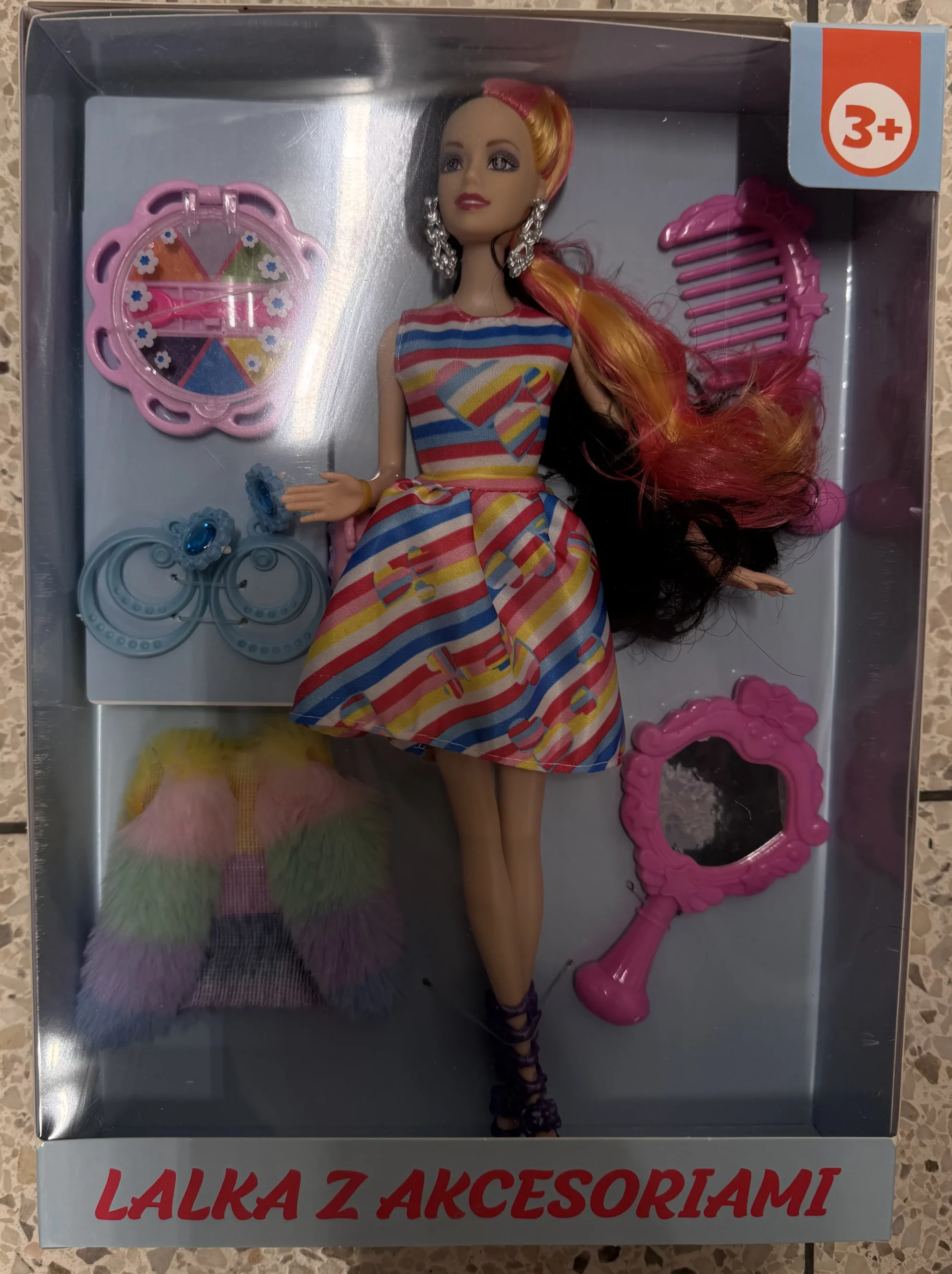 Plastic doll with plastic accessories.