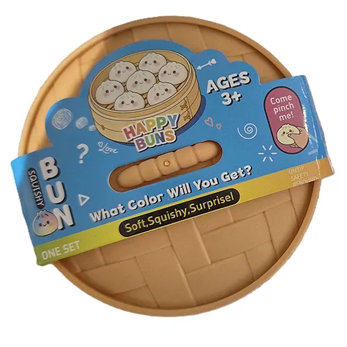 Squeeze toy in the shape of a Chinese dumpling in a plastic container made to resemble a bamboo steamer.