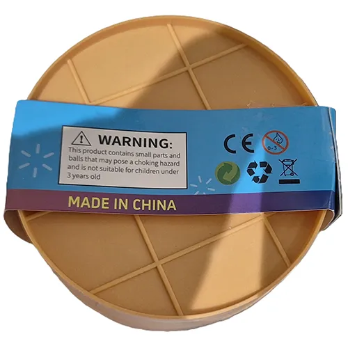 Squeeze toy in the shape of a Chinese dumpling in a plastic container made to resemble a bamboo steamer.