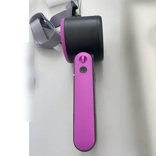 Rechargeable handheld folding fan with a plastic housing in black and pink, sold with a USB charging cable and wrist strap.