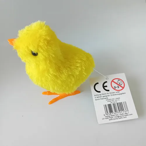 Wind-up toy in the shape of a chicken made of rigid plastic and covered with soft fabric. When the key is wound up, the toy moves.