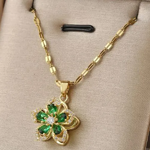 Necklace with a green pendant in the shape of a flower.