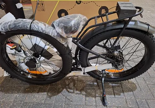 Electric bicycle with wall plug and charging supply.