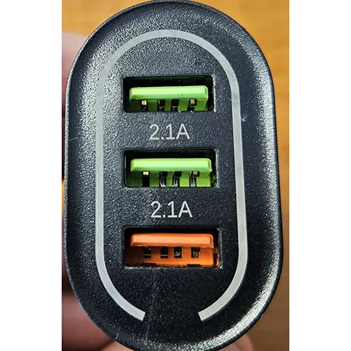 Black battery charger with three USB-A ports. Output: 5V/9V/12V.