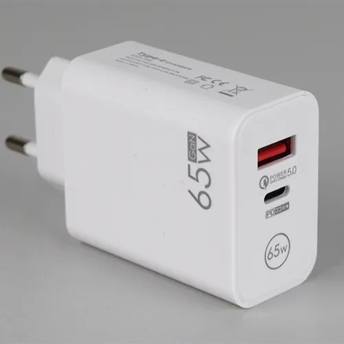 White USB charger with one USB-A and one USB-C port, integrated with a mains plug. Input: 100-240 V, 50/60 Hz, 0.5 A. Output: 9 V/7.2 A, 12 V/5.4 A, 20 V/3.25 A.