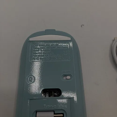 Wireless mouse with USB charging cable.