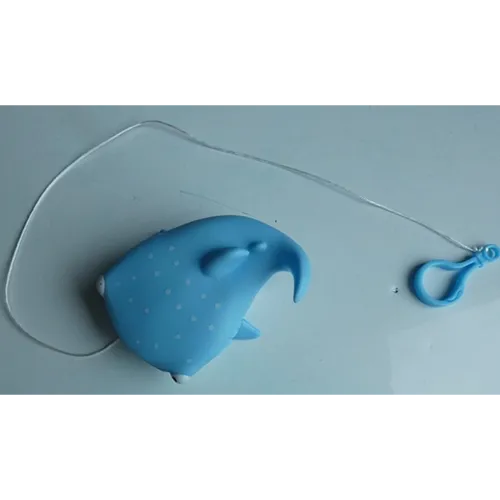 Bath toy in the shape of a shark with an attached cord and plastic hook.
