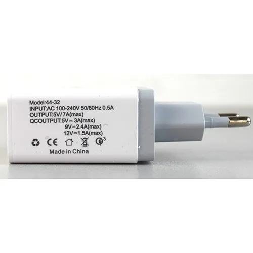 White and grey plastic USB charger with an integrated European plug, featuring four USB Type-A output ports on the face interface, with one port highlighted for quick charging.
